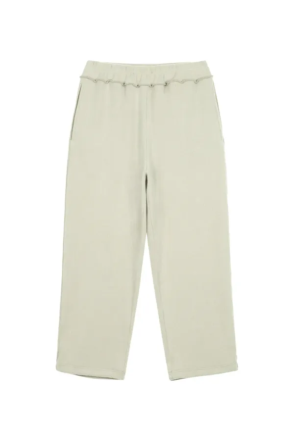 SMOOTH D LOGO KNIT PANTS IN ASH BEIGE